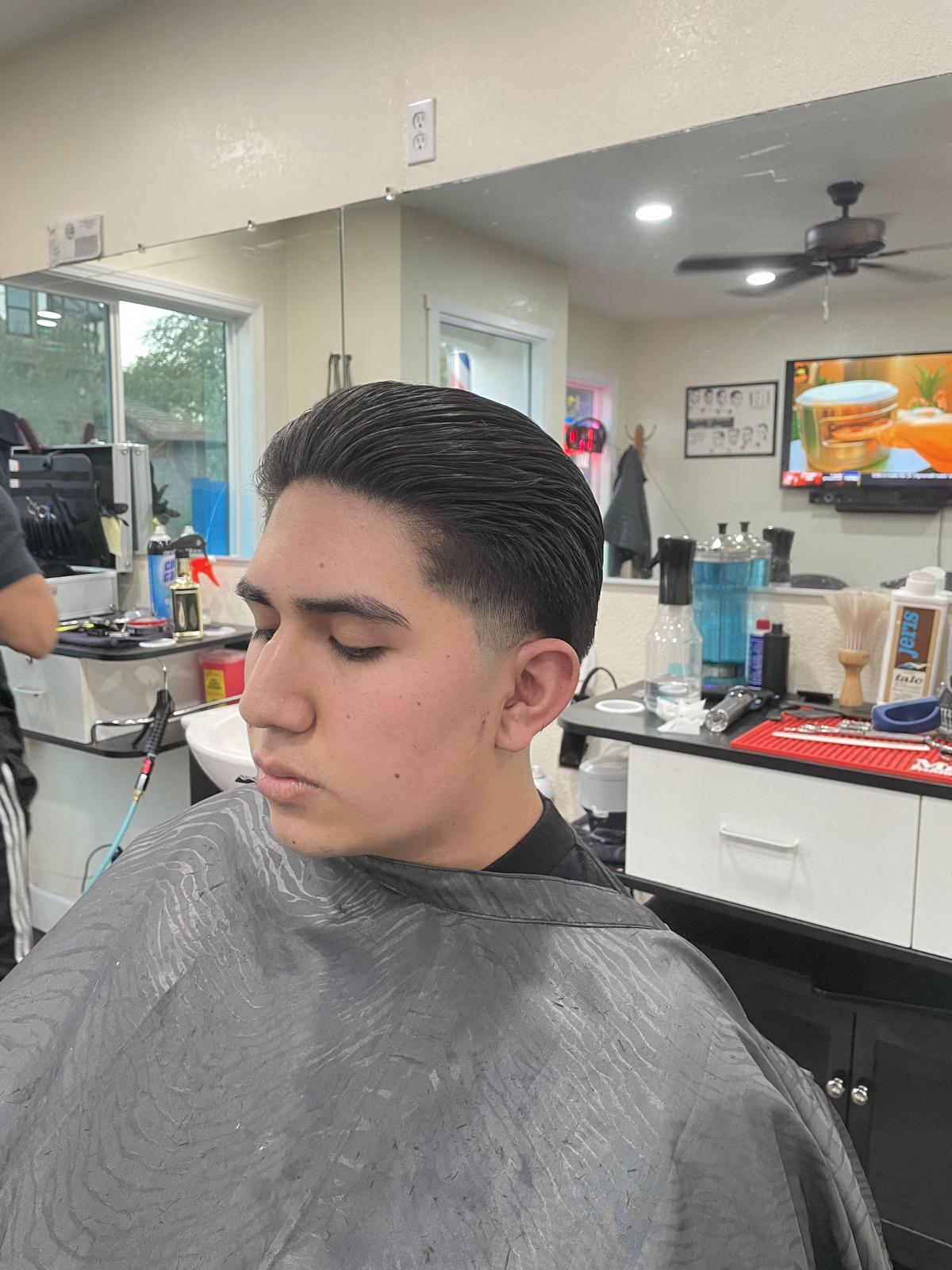 Client with a comb-over taper viewed from the side