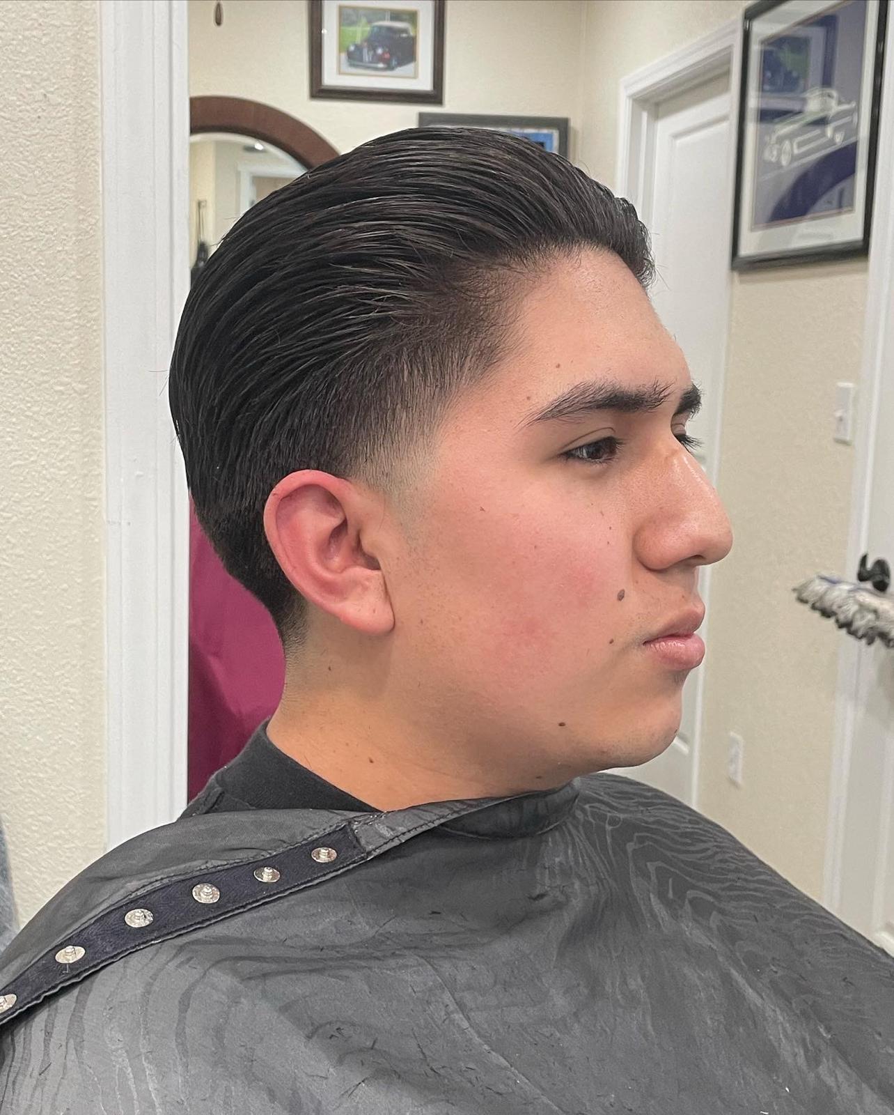Client with a slicked-back classic taper haircut