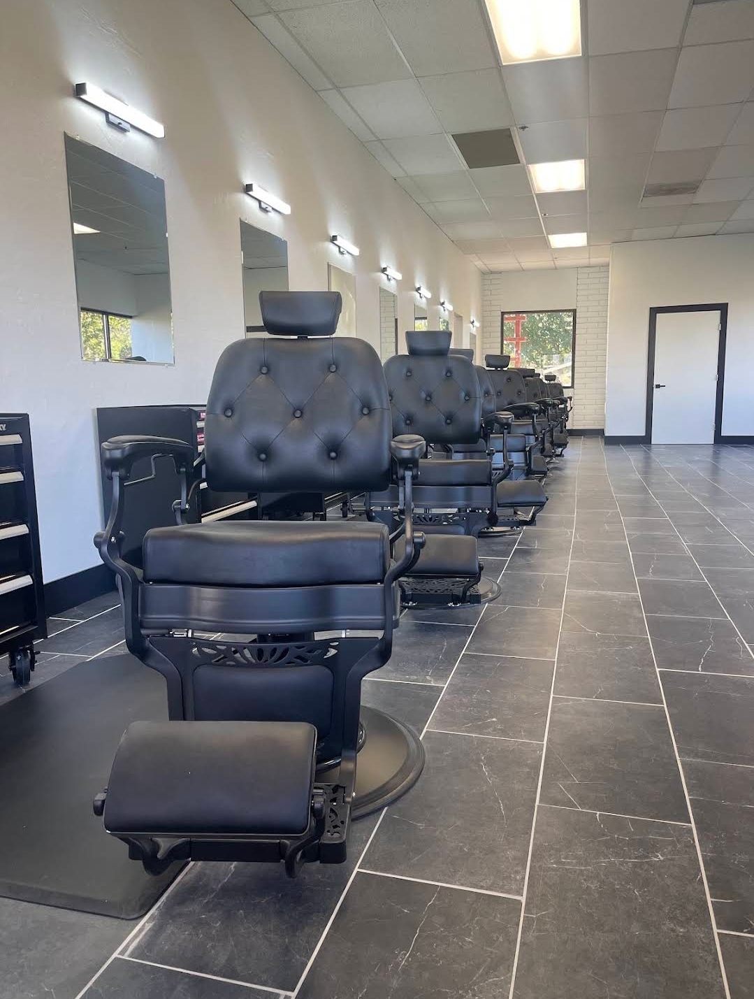 Interior of Oscar Medina Barbershop with leather chairs and wooden mirrors