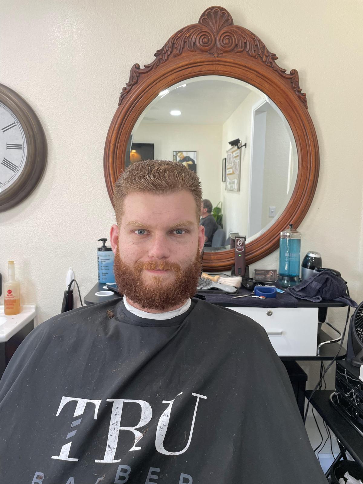 Client with a textured crop and sculpted red beard